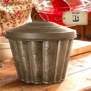 Vintage aluminum Jell-O mold with lid on rustic kitchen table